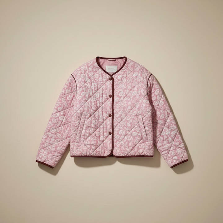 pink floral quilted jacket displayed flat against beige background showing full front design