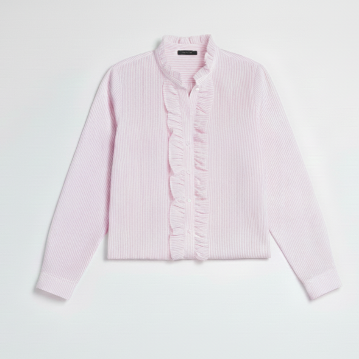Flatlay of a pink women’s ruffle button shirt placed on a light background for a clean product presentation.