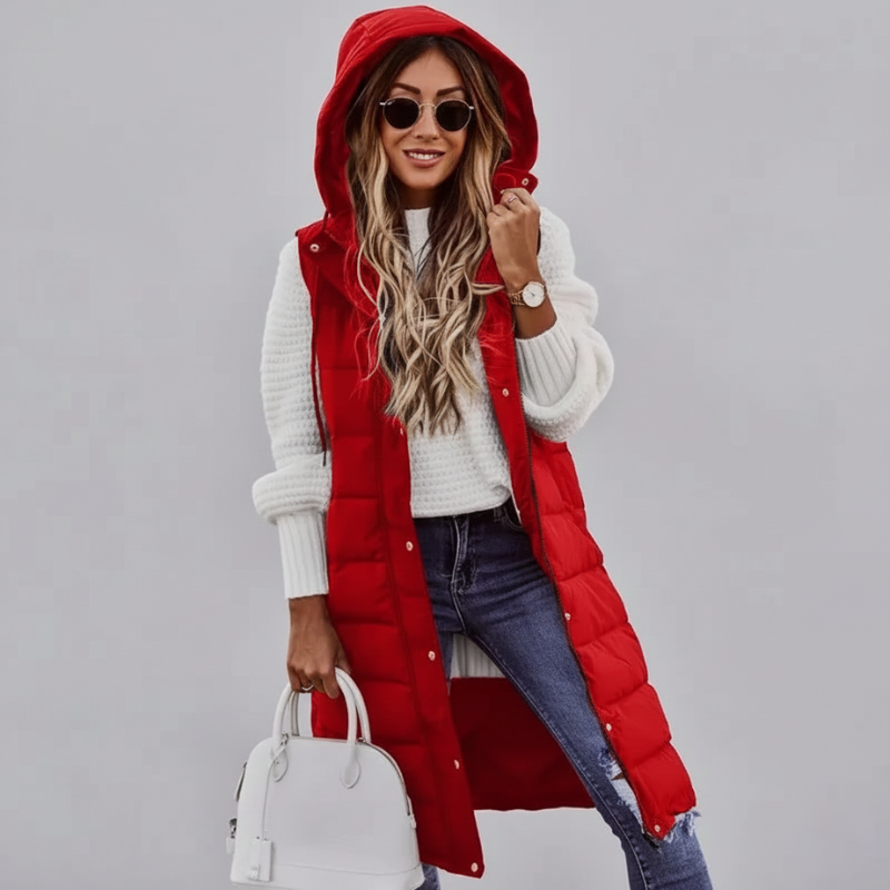 female model wearing red long puffer vest with hood giving a warm winter look